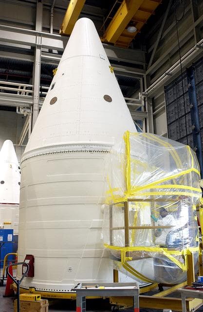 NASA image: KENNEDY SPACE CENTER, FLA. - In the Solid Rocket Booster Assembly and Refurbishment Facility (ARF), Vernon Gibbs, with United Space Alliance, prepares the forward skirt of a solid rocket booster for installation of the parachute camera.  Refurbishment and subassembly of Shuttle SRB hardware - primarily the forward and aft assemblies - is carried out in the ARF.