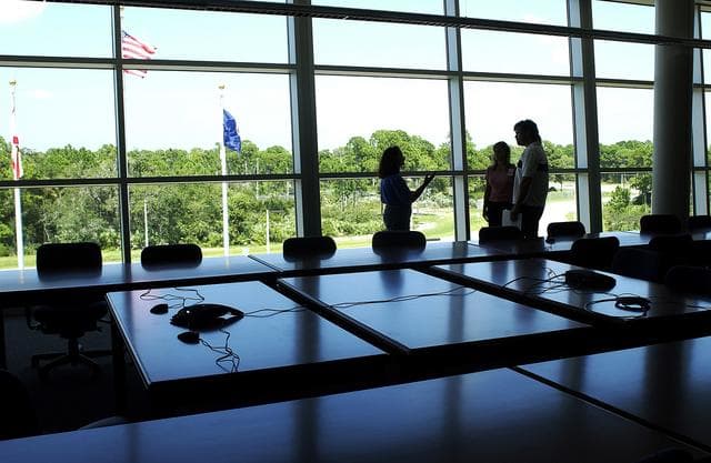 NASA image: KENNEDY SPACE CENTER, FLA. - Dynamac employees Debbie Wells, Michelle Crouch and Larry Burns are silhouetted as they talk inside a conference room of the Space Life Sciences Lab (SLSL), formerly known as the Space Experiment Research and Processing Laboratory (SERPL).  They have been transferring equipment from Hangar L.  The new lab is a state-of-the-art facility being built for ISS biotechnology research. Developed as a partnership between NASA-KSC and the State of Florida, NASA’s life sciences contractor will be the primary tenant of the facility, leasing space to conduct flight experiment processing and NASA-sponsored research. About 20 percent of the facility will be available for use by Florida’s university researchers through the Florida Space Research Institute.