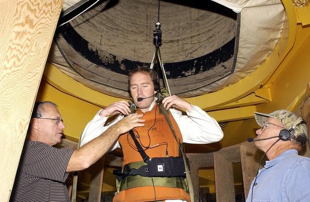 NASA image: KENNEDY SPACE CENTER, FLA. -   Jeff Thon, an SRB mechanic with United Space Alliance, is fitted with a harness to test a vertical solid rocket booster propellant grain inspection technique.  Thon will be lowered inside a mockup of two segments of the SRBs.  The inspection of segments is required as part of safety analysis.