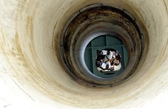 NASA image: KENNEDY SPACE CENTER, FLA. -   Seen from below and through a solid rocket booster segment mockup, Jeff Thon, an SRB mechanic with United Space Alliance, tests the feasibility of a vertical solid rocket booster propellant grain inspection technique.  The inspection of segments is required as part of safety analysis.