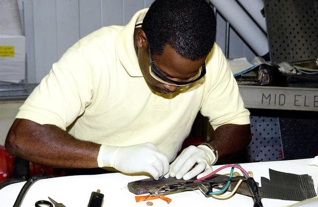 NASA image: KENNEDY SPACE CENTER, FLA. -  United Space Alliance employee Anthony Simmons prepares to electroweld a crack formed in the insulator inside a Reinforced Carbon Carbon panel.   The gray carbon composite RCC panels are attached to the leading edge of the wing of the orbiters to withstand the aerodynamic forces experienced during launch and reentry, which can reach as high as 800 pounds per square foot.  The operating range of RCC is from minus 250º F to about 3,000º F, the temperature produced by friction with the atmosphere during reentry.
