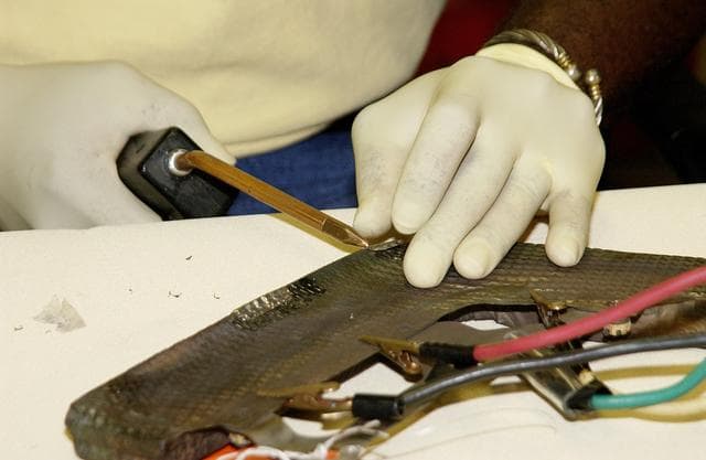 NASA image: KENNEDY SPACE CENTER, FLA. -   United Space Alliance employee Anthony Simmons continues electrowelding on an insulator inside a Reinforced Carbon Carbon panel.   The gray carbon composite RCC panels are attached to the leading edge of the wing of the orbiters to withstand the aerodynamic forces experienced during launch and reentry, which can reach as high as 800 pounds per square foot.  The operating range of RCC is from minus 250º F to about 3,000º F, the temperature produced by friction with the atmosphere during reentry.