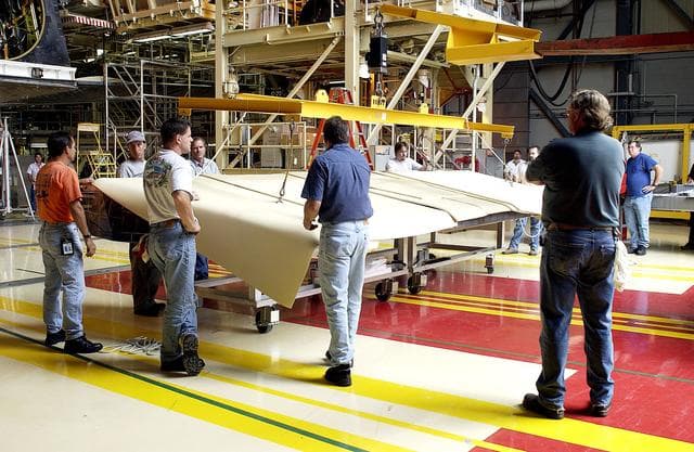 NASA image: KENNEDY SPACE CENTER, FLA. -   Workers in the Orbiter Processing Facility get ready to lift and install the rear body flap on orbiter Discovery.  The body flap, which is temporarily under protective covering, attaches below the main engines.
