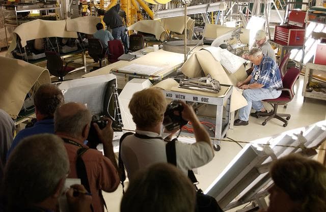 NASA image: KENNEDY SPACE CENTER, FLA. -  In the Orbiter Processing Facility, the media record workers on the job preparing the orbiter Atlantis for Return to Flight. Both local and national reporters representing print and TV networks were invited to see work in progress on Atlantis, including the reinstallation of the Reinforced Carbon-Carbon panels on the orbiter’s wing leading edge; wiring inspections; and checks of the engines in the Orbital Maneuvering System.