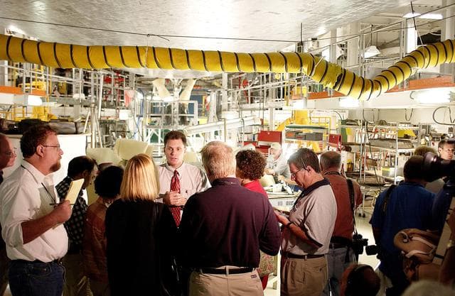 NASA image: KENNEDY SPACE CENTER, FLA. -  NASA Vehicle Manager Scott Thurston (facing camera) talks to the media in the Orbiter Processing Facility.  The media was invited to see the orbiter Atlantis as it is being prepared for Return to Flight.  Both local and national reporters representing print and TV networks were able to see work in progress on Atlantis, including the reinstallation of the Reinforced Carbon-Carbon panels on the orbiter’s wing leading edge; wiring inspections; and checks of the engines in the Orbital Maneuvering System.