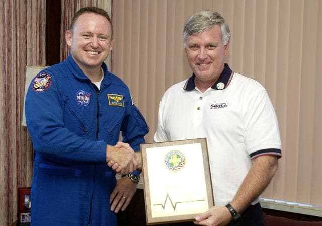 NASA image: KENNEDY SPACE CENTER, FLA. -  Astronaut Barry E. Wilmore (left) and Center Director Jim Kennedy pose for a photo after Wilmore presented Kennedy with a special award for Spaceport Super Safety and Health Day.