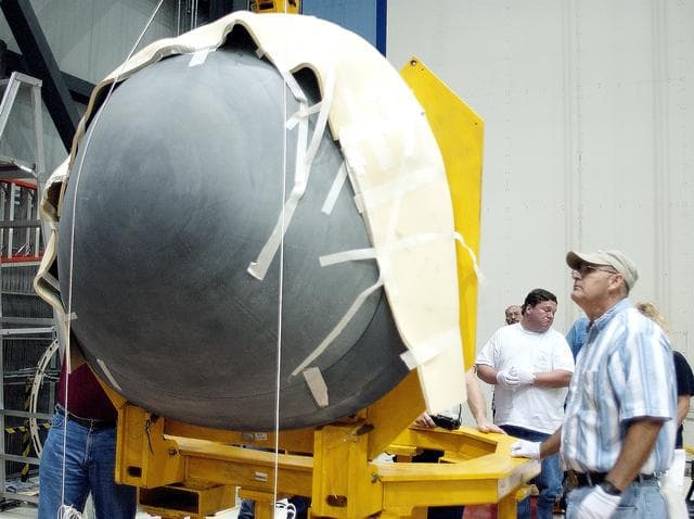 NASA image: KENNEDY SPACE CENTER, FLA. -  In the Orbiter Processing Facility, the nose cap of the orbiter Atlantis rests on a stand after its removal from the orbiter for routine inspection. The nose cap is made of reinforced carbon-carbon (RCC), which has an operating range of minus 250° F to about 3,000° F.