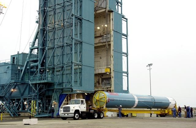 NASA image: VANDENBERG AFB, CALIF. -  The first stage of the Delta II launch vehicle for the Gravity Probe B experiment arrives at Space Launch Complex 2, Vandenberg Air Force Base, Calif.  The Gravity Probe B will launch a payload of four gyroscopes into low-Earth polar orbit to test two extraordinary predictions of Albert Einstein’s general theory of relativity: the geodetic effect (how space and time are warped by the presence of the Earth) and frame dragging (how Earth’s rotation drags space and time around with it). Once in orbit, for 18 months each gyroscope’s spin axis will be monitored as it travels through local spacetime, observing and measuring these effects.  The experiment was developed by Stanford University, Lockheed Martin and NASA’s Marshall Space Flight Center.  The targeted launch date is Dec. 6, 2003.
