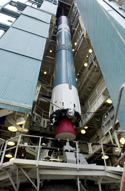 NASA image: VANDENBERG AFB, CALIF. -   The first stage of the Delta II launch vehicle for the Gravity Probe B experiment is lifted up the mobile service tower on Space Launch Complex 2, Vandenberg Air Force Base, Calif.  The Gravity Probe B will launch a payload of four gyroscopes into low-Earth polar orbit to test two extraordinary predictions of Albert Einstein’s general theory of relativity: the geodetic effect (how space and time are warped by the presence of the Earth) and frame dragging (how Earth’s rotation drags space and time around with it). Once in orbit, for 18 months each gyroscope’s spin axis will be monitored as it travels through local spacetime, observing and measuring these effects.  The experiment was developed by Stanford University, Lockheed Martin and NASA’s Marshall Space Flight Center.  The targeted launch date is Dec. 6, 2003.