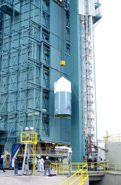 NASA image: VANDENBERG AFB, CALIF. -  The interstage of the Delta II launch vehicle for the Gravity Probe B experiment is lifted up the mobile service tower on Space Launch Complex 2, Vandenberg Air Force Base, Calif.  It will enclose the second stage.  The Gravity Probe B will launch a payload of four gyroscopes into low-Earth polar orbit to test two extraordinary predictions of Albert Einstein’s general theory of relativity: the geodetic effect (how space and time are warped by the presence of the Earth) and frame dragging (how Earth’s rotation drags space and time around with it). Once in orbit, for 18 months each gyroscope’s spin axis will be monitored as it travels through local spacetime, observing and measuring these effects.  The experiment was developed by Stanford University, Lockheed Martin and NASA’s Marshall Space Flight Center.  The targeted launch date is Dec. 6, 2003.