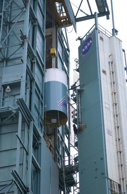 NASA image: VANDENBERG AFB, CALIF. -   The interstage of the Delta II launch vehicle for the Gravity Probe B experiment is moved into the mobile service tower on Space Launch Complex 2, Vandenberg Air Force Base, Calif., where it will be mated with the second stage.  The Gravity Probe B will launch a payload of four gyroscopes into low-Earth polar orbit to test two extraordinary predictions of Albert Einstein’s general theory of relativity: the geodetic effect (how space and time are warped by the presence of the Earth) and frame dragging (how Earth’s rotation drags space and time around with it). Once in orbit, for 18 months each gyroscope’s spin axis will be monitored as it travels through local spacetime, observing and measuring these effects.  The experiment was developed by Stanford University, Lockheed Martin and NASA’s Marshall Space Flight Center.  The targeted launch date is Dec. 6, 2003.
