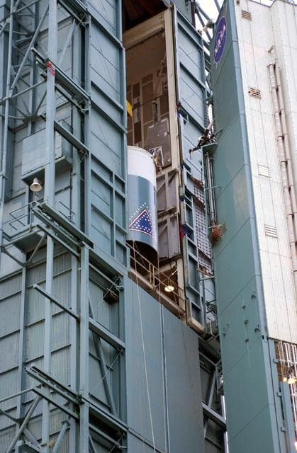 NASA image: VANDENBERG AFB, CALIF. -   The interstage of the Delta II launch vehicle for the Gravity Probe B experiment is moved into the mobile service tower on Space Launch Complex 2, Vandenberg Air Force Base, Calif., where it will be mated with the second stage.  The Gravity Probe B will launch a payload of four gyroscopes into low-Earth polar orbit to test two extraordinary predictions of Albert Einstein’s general theory of relativity: the geodetic effect (how space and time are warped by the presence of the Earth) and frame dragging (how Earth’s rotation drags space and time around with it). Once in orbit, for 18 months each gyroscope’s spin axis will be monitored as it travels through local spacetime, observing and measuring these effects.  The experiment was developed by Stanford University, Lockheed Martin and NASA’s Marshall Space Flight Center.  The targeted launch date is Dec. 6, 2003.