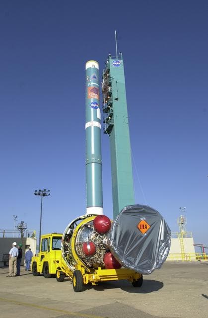NASA image: VANDENBERG AFB, CALIF. -  The second stage of the Delta II launch vehicle for the Gravity Probe B experiment arrives at the mobile service tower on Space Launch Complex 2, Vandenberg Air Force Base, Calif.  The Gravity Probe B will launch a payload of four gyroscopes into low-Earth polar orbit to test two extraordinary predictions of Albert Einstein’s general theory of relativity: the geodetic effect (how space and time are warped by the presence of the Earth) and frame dragging (how Earth’s rotation drags space and time around with it). Once in orbit, for 18 months each gyroscope’s spin axis will be monitored as it travels through local spacetime, observing and measuring these effects.  The experiment was developed by Stanford University, Lockheed Martin and NASA’s Marshall Space Flight Center.  The targeted launch date is Dec. 6, 2003.