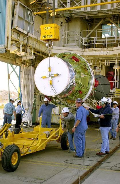 NASA image: VANDENBERG AFB, CALIF. - The second stage of the Delta II launch vehicle for the Gravity Probe B experiment is lifted off the transporter after its arrival on Space Launch Complex 2, Vandenberg Air Force Base, Calif.  The Gravity Probe B will launch a payload of four gyroscopes into low-Earth polar orbit to test two extraordinary predictions of Albert Einstein’s general theory of relativity: the geodetic effect (how space and time are warped by the presence of the Earth) and frame dragging (how Earth’s rotation drags space and time around with it). Once in orbit, for 18 months each gyroscope’s spin axis will be monitored as it travels through local spacetime, observing and measuring these effects.  The experiment was developed by Stanford University, Lockheed Martin and NASA’s Marshall Space Flight Center.  The targeted launch date is Dec. 6, 2003.