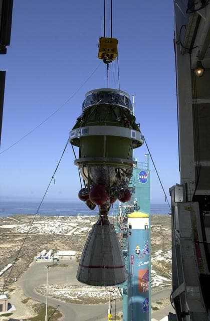 NASA image: VANDENBERG AFB, CALIF. -  Viewed from inside, the second stage of the Delta II launch vehicle for the Gravity Probe B experiment is lifted up the mobile service tower on Space Launch Complex 2, Vandenberg Air Force Base, Calif.   Behind it is the first stage of the Delta II.  The Gravity Probe B will launch a payload of four gyroscopes into low-Earth polar orbit to test two extraordinary predictions of Albert Einstein’s general theory of relativity: the geodetic effect (how space and time are warped by the presence of the Earth) and frame dragging (how Earth’s rotation drags space and time around with it). Once in orbit, for 18 months each gyroscope’s spin axis will be monitored as it travels through local spacetime, observing and measuring these effects.  The experiment was developed by Stanford University, Lockheed Martin and NASA’s Marshall Space Flight Center.  The targeted launch date is Dec. 6, 2003.