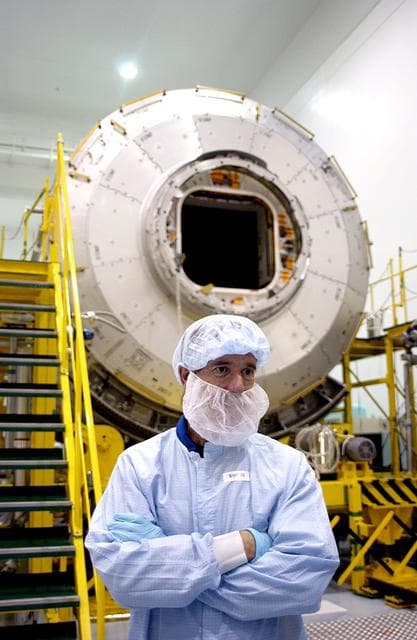 NASA image: KENNEDY SPACE CENTER, FLA. -  In the Space Station Processing Facility, STS-117 Mission Specialist James Reilly stands in front of the Japanese Experiment Module (JEM).  Reilly and STS-115 Mission Specialist Joseph Tanner are at KSC for equipment familiarization, a routine part of astronaut training and launch preparations.