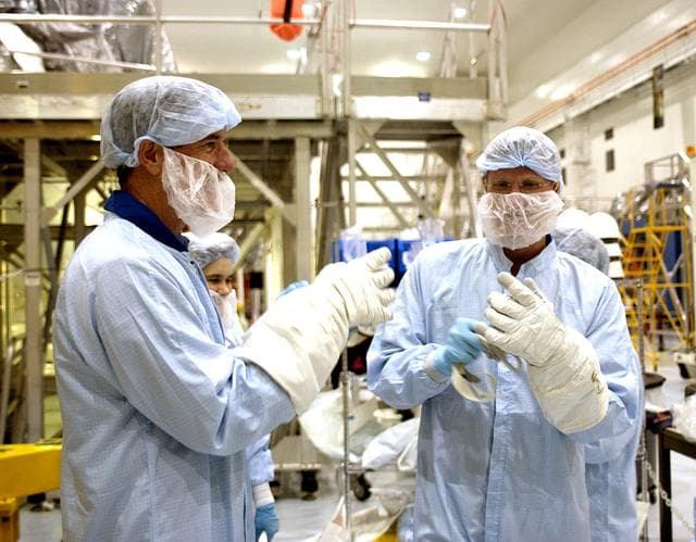 NASA image: KENNEDY SPACE CENTER, FLA. -  STS-117 Mission Specialist James Reilly (left) and STS-115 Mission Specialist Joseph Tanner (right) put on protective gloves before their checkout of the Japanese Experiment Module (JEM) in the Space Station Processing Facility.  Reilly and Tanner are at KSC for equipment familiarization, a routine part of astronaut training and launch preparations.