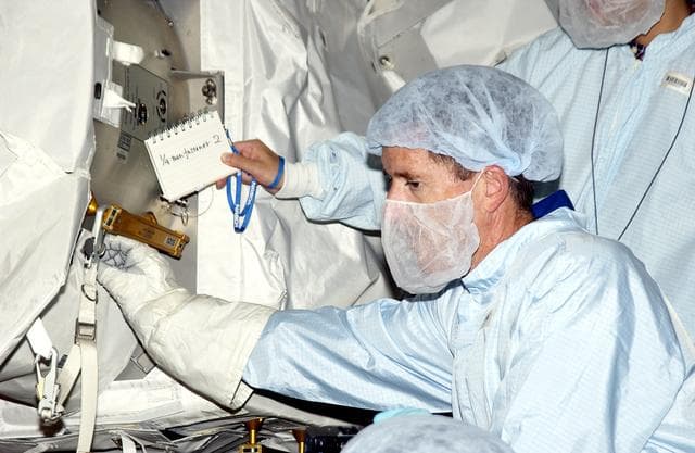 KENNEDY SPACE CENTER, FLA. - In the Space Station Processing Facility, STS-117 Mission Specialist James Reilly  works with equipment in the Japanese Experiment Module (JEM) as part of training for ExtraVehicular Activity (EVA).  Equipment familiarization is a routine part of astronaut training and launch preparations.