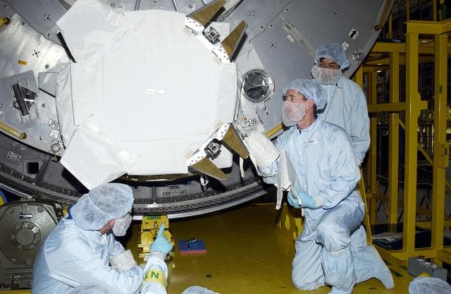 NASA image: KENNEDY SPACE CENTER, FLA. - In the Space Station Processing Facility, STS-117 Mission Specialist James Reilly (right, in front) works with equipment in the Japanese Experiment Module (JEM) as part of training for ExtraVehicular Activity (EVA). At left is STS-115 Mission Specialist Joseph Tanner.  Equipment familiarization is a routine part of astronaut training and launch preparations.