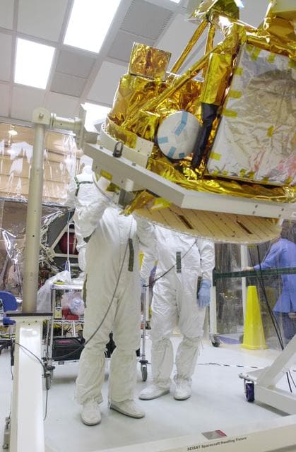NASA image: VANDENBERG AIR FORCE BASE, CALIF. -  With its cover removed, the SciSat-1 spacecraft is rotated.  The solar arrays will be attached and the communications systems checked out.   The SciSat-1 weighs approximately 330 pounds and after launch will be placed in a 400-mile-high polar orbit to investigate processes that control the distribution of ozone in the upper atmosphere. The data from the satellite will provide Canadian and international scientists with improved measurements relating to global ozone processes and help policymakers assess existing environmental policy and develop protective measures for improving the health of our atmosphere, preventing further ozone depletion. The mission is designed to last two years.