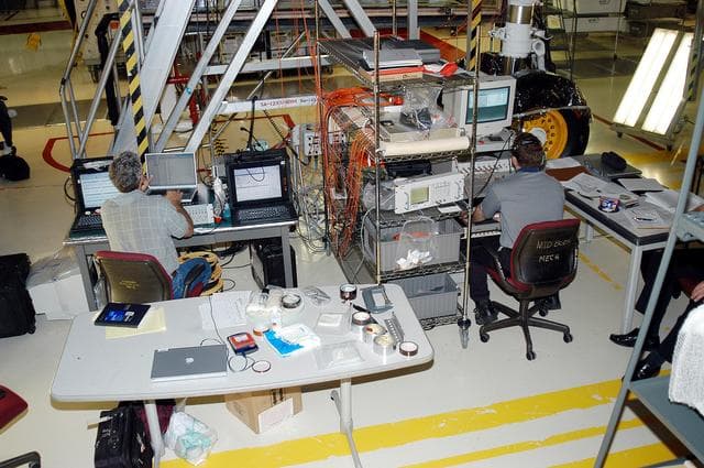 NASA image: KENNEDY SPACE CENTER, FLA. -  In the Orbiter Processing Facility, Eric Madaras (left), NASA-Langley Research Center, and Jim McGee, The Boeing Company, Huntington Beach, Calif., conduct impulse tests on the right wing leading edge (WLE) of Space Shuttle Endeavour. The tests monitor how sound impulses propagate through the WLE area.  The data collected will be analyzed to explore the possibility of adding new instrumentation to the wing that could automatically detect debris or micrometeroid impacts on the Shuttle while in flight.  The study is part of the initiative ongoing at KSC and around the agency to return the orbiter fleet to flight status.