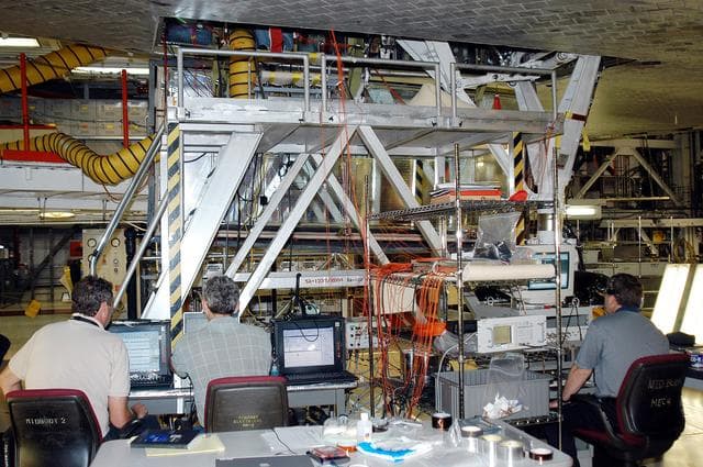 NASA image: KENNEDY SPACE CENTER, FLA. -  In the Orbiter Processing Facility, Bill Prosser (left) and Eric Madaras, NASA-Langley Research Center, and Jim McGee (right), The Boeing Company, Huntington Beach, Calif., conduct impulse tests on the right wing leading edge (WLE) of Space Shuttle Endeavour. The tests monitor how sound impulses propagate through the WLE area.  The data collected will be analyzed to explore the possibility of adding new instrumentation to the wing that could automatically detect debris or micrometeroid impacts on the Shuttle while in flight.  The study is part of the initiative ongoing at KSC and around the agency to return the orbiter fleet to flight status.