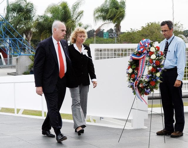 NASA image: KENNEDY SPACE CENTER, FLA. -  NASA's Associate Administrator for Space Flight William Readdy (left) and Evelyn Husband, widow of astronaut Rick Husband, place a ceremonial wreath at the Space Mirror Memorial at the Kennedy Space Center Visitor Complex.  During this dedication ceremony, the names of the STS-107 astronauts who lost their lives during the Columbia accident -- Rick Husband, Willie McCool, Laurel Clark, Michael Anderson, David Brown, Kalpana Chawla, and Ilan Ramon -- join the names of 17 other space heroes who gave their lives for the U.S. space program. The "Space Mirror," 42 1/2 feet high by 50 feet wide, illuminates the names of the fallen astronauts cut through the monument's black granite surface.