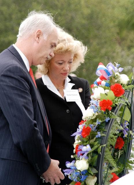 NASA image: KENNEDY SPACE CENTER, FLA. -  NASA's Associate Administrator for Space Flight William Readdy and Evelyn Husband, widow of astronaut Rick Husband, place a ceremonial wreath at the Space Mirror Memorial at the Kennedy Space Center Visitor Complex.  During this dedication ceremony, the names of the STS-107 astronauts who lost their lives during the Columbia accident -- Rick Husband, Willie McCool, Laurel Clark, Michael Anderson, David Brown, Kalpana Chawla, and Ilan Ramon -- join the names of 17 other space heroes who gave their lives for the U.S. space program. The "Space Mirror," 42 1/2 feet high by 50 feet wide, illuminates the names of the fallen astronauts cut through the monument's black granite surface.