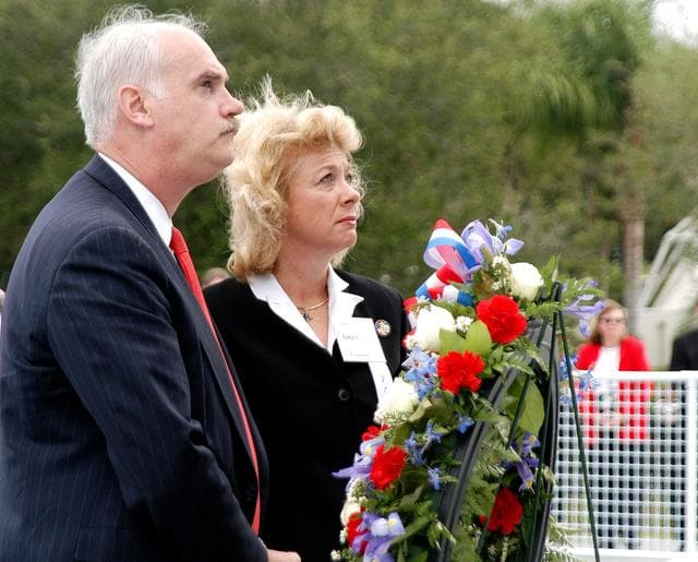 NASA image: KENNEDY SPACE CENTER, FLA. -  NASA's Associate Administrator for Space Flight William Readdy and Evelyn Husband, widow of astronaut Rick Husband, place a ceremonial wreath at the Space Mirror Memorial at the Kennedy Space Center Visitor Complex.  During this dedication ceremony, the names of the STS-107 astronauts who lost their lives during the Columbia accident -- Rick Husband, Willie McCool, Laurel Clark, Michael Anderson, David Brown, Kalpana Chawla, and Ilan Ramon -- join the names of 17 other space heroes who gave their lives for the U.S. space program. The "Space Mirror," 42 1/2 feet high by 50 feet wide, illuminates the names of the fallen astronauts cut through the monument's black granite surface.