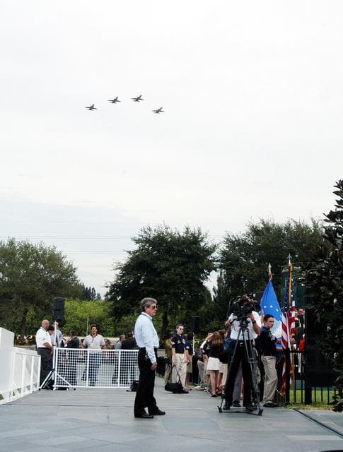 NASA image: KENNEDY SPACE CENTER, FLA. -  NASA T-38 jets fly over the Space Mirror Memorial at the Kennedy Space Center Visitor Complex in the Missing Man Formation. During this dedication ceremony, the names of the STS-107 astronauts who lost their lives during the Columbia accident -- Rick Husband, Willie McCool, Laurel Clark, Michael Anderson, David Brown, Kalpana Chawla, and Ilan Ramon -- join the names of 17 other space heroes who gave their lives for the U.S. space program. The "Space Mirror," 42 1/2 feet high by 50 feet wide, illuminates the names of the fallen astronauts cut through the monument's black granite surface.