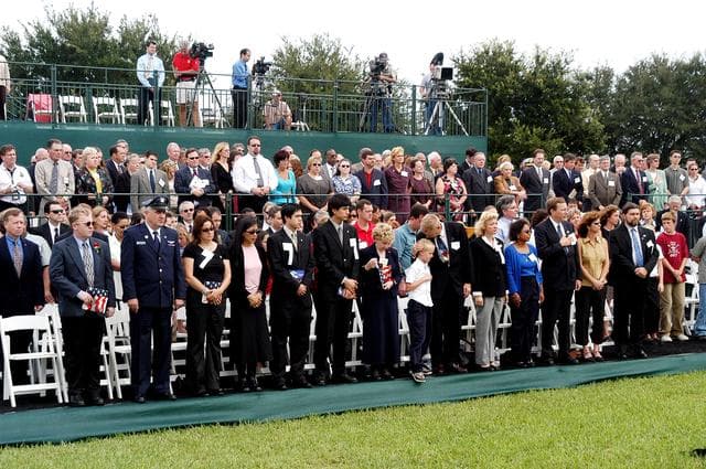 NASA image: KENNEDY SPACE CENTER, FLA. -  Family members of the STS-107 astronauts and other dignitaries attend a dedication ceremony at the Space Mirror Memorial at the Kennedy Space Center Visitor Complex.  During this solemn event, the names of the STS-107 astronauts who lost their lives during the Columbia accident -- Rick Husband, Willie McCool, Laurel Clark, Michael Anderson, David Brown, Kalpana Chawla, and Ilan Ramon -- join the names of 17 other space heroes who gave their lives for the U.S. space program. The "Space Mirror," 42 1/2 feet high by 50 feet wide, illuminates the names of the fallen astronauts cut through the monument's black granite surface.