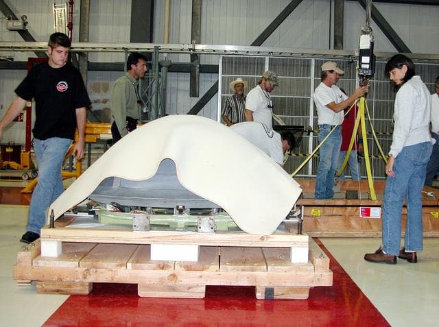 NASA image: KENNEDY SPACE CENTER, FLA. -  In the Orbiter Processing Facility, packing material is placed over the nose cap that was removed from Atlantis.   The reinforced carbon-carbon (RCC) nose cap is being sent to the original manufacturing company, Vought in Ft. Worth, Texas, a subsidiary of Lockheed Martin, to undergo non-destructive testing such as CAT scan and thermography.