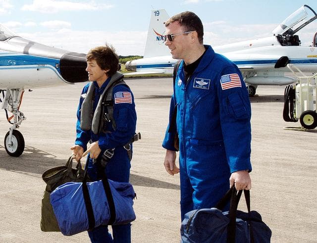 NASA image: KENNEDY SPACE CENTER, FLA. - Walking away from the T-38 jet aircraft that brought them to KSC are STS-114 Mission Specialist Wendy Lawrence and Pilot James Kelly.  Lawrence is a new addition to the crew.  They and other crew members are at KSC to take part in crew equipment and orbiter familiarization.
