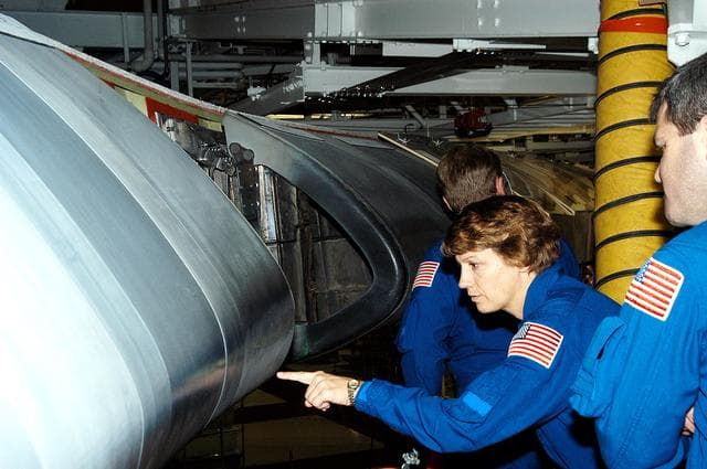 NASA image: KENNEDY SPACE CENTER, FLA. -  In the Orbiter Processing Facility, STS-114 Mission Commander Eileen Collins looks closely at a reinforced carbon-carbon panel on the wing of Atlantis.  She and other crew members are at KSC to take part in crew equipment and orbiter familiarization.