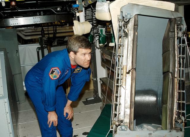 NASA image: KENNEDY SPACE CENTER, FLA. -   Astronaut Stephen Frick takes a close look at a reinforced carbon-carbon panel to be installed on orbiter Atlantis.  Frick is a tile specialist, who joined the STS-114 crew during crew equipment and orbiter familiarization in the Orbiter Processing Facility.