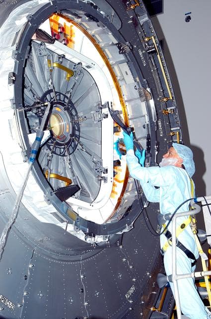 NASA image: KENNEDY SPACE CENTER, FLA. - In the Space Station Processing Facility, a technician takes readings for pre-assembly measurements on the Japanese Experiment Module (JEM).  Developed by the Japan Aerospace Exploration Agency (JAXA), the JEM will enhance the unique research capabilities of the orbiting complex by providing an additional environment for astronauts to conduct science experiments.