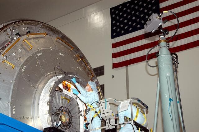 NASA image: KENNEDY SPACE CENTER, FLA. - In the Space Station Processing Facility, a technician takes readings for pre-assembly measurements on the Japanese Experiment Module (JEM).  Developed by the Japan Aerospace Exploration Agency (JAXA), the JEM will enhance the unique research capabilities of the orbiting complex by providing an additional environment for astronauts to conduct science experiments.