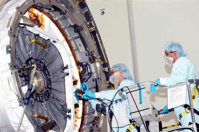 NASA image: KENNEDY SPACE CENTER, FLA. - In the Space Station Processing Facility, technicians take readings for pre-assembly measurements on the Japanese Experiment Module (JEM).  Developed by the Japan Aerospace Exploration Agency (JAXA), the JEM will enhance the unique research capabilities of the orbiting complex by providing an additional environment for astronauts to conduct science experiments.