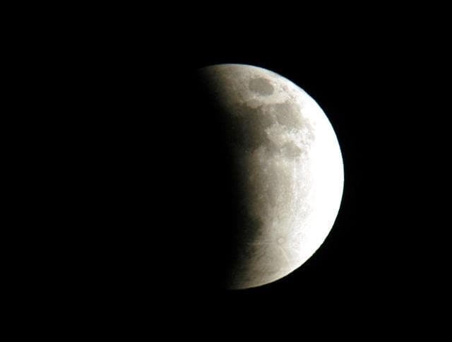 KENNEDY SPACE CENTER, FLA. - The start of a lunar eclipse is viewed from Merritt Island, Fla.  Eclipses occur when the Sun, Earth and Moon line up. They are rare because the Moon usually passes above or below the imaginary line connecting Earth and the Sun. The Earth casts a shadow that the Moon can pass through - when it does, it is called a lunar eclipse.
