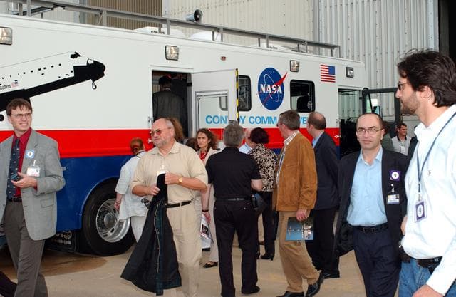 NASA image: KENNEDY SPACE CENTER, FLA. - During their tour of KSC, members of the North American Treaty Organization (NATO) Parliamentary Assembly visit the Convoy Command Center, the prime vehicle to control critical communications between the orbiter, the crew and the Launch Control Center after a Shuttle landing, to monitor the health of the Shuttle Orbiter systems and to direct convoy operations at the Shuttle Landing Facility. The Parliamentarians are meeting in Orlando this year for their 49th annual gathering.  They chose to visit KSC with their families during their one-day excursion break from meetings.