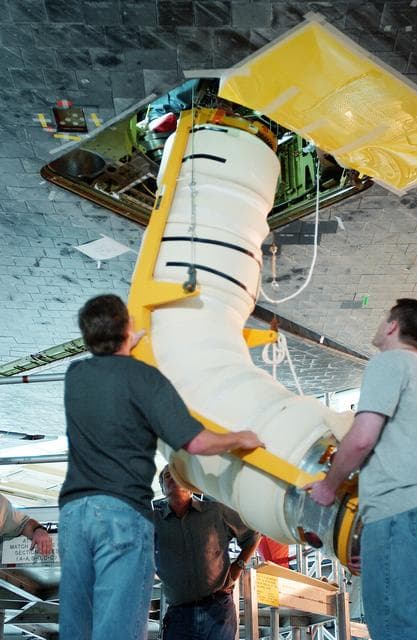 NASA image: KENNEDY SPACE CENTER, FLA. -  In the Orbiter Processing Facility, workers install the liquid oxygen feedline for the 17-inch disconnect on orbiter Discovery. The 17-inch liquid oxygen and liquid hydrogen disconnects provide the propellant feed interface from the external tank to the orbiter main propulsion system and the three Shuttle main engines.