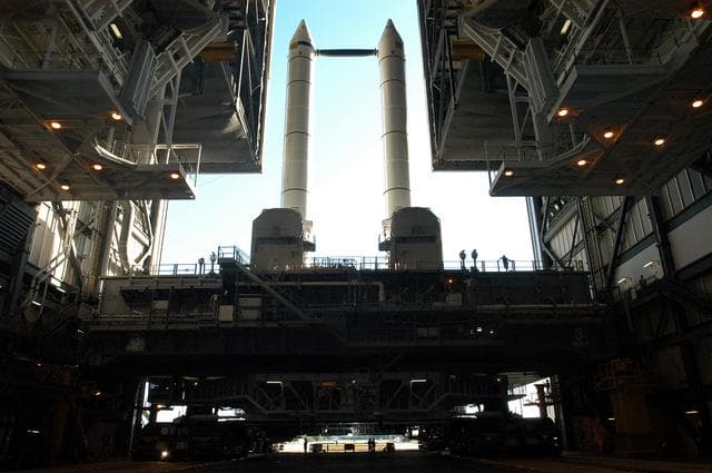 NASA image: KENNEDY SPACE CENTER, FLA. -   The crawler transporter is slowly moving the Mobile Launcher Platform (MLP), carrying a set of twin solid rocket boosters, out of the Vehicle Assembly Building (VAB) in support of engineering analysis vibration tests on the crawler and MLP. The crawler is moving at various speeds up to 1 mph in an effort to achieve vibration data gathering goals as it leaves the VAB and then returns.  The boosters are braced at the top for stability.  The primary purpose of these rollout tests is to gather data to develop future maintenance requirements on the transport equipment and the flight hardware. Various parts of the MLP and crawler transporter have been instrumented with vibration data collection equipment.