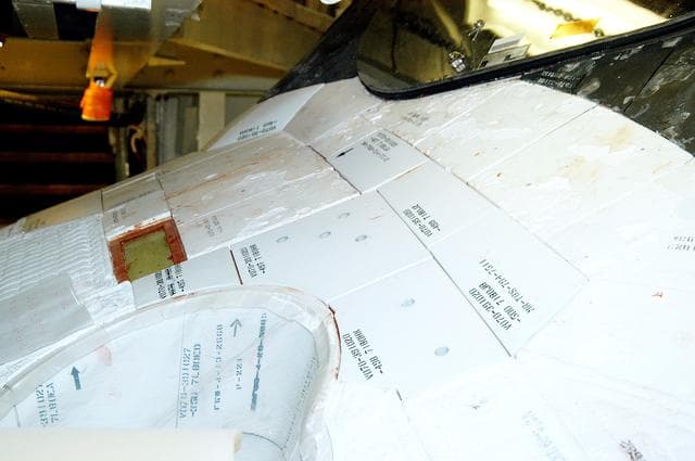 NASA image: KENNEDY SPACE CENTER, FLA. - This view shows the tiles below the windshield on the orbiter Atlantis.  A gap test is being performed on the tiles as part of return-to-flight activities.  Atlantis is scheduled for mission STS-114, a return-to-flight test mission to the International Space Station.