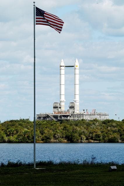 NASA image: KENNEDY SPACE CENTER, FLA. -  Mobile Launcher Platform (MLP) number 3 and a set of twin solid rocket boosters bolted to it, atop the crawler-transporter, inches along the crawlerway in support of the second engineering analysis vibration test on the crawler and MLP.  The MLP is viewed from the KSC News Center across the turn basin.  The crawler is moving at various speeds up to 1 mph in an effort to achieve vibration data gathering goals as it leaves the VAB, travels toward Launch Pad 39A and then returns.  The boosters are braced at the top for stability.  The primary purpose of these rollout tests is to gather data to develop future maintenance requirements on the transport equipment and the flight hardware. Various parts of the MLP and crawler transporter have been instrumented with vibration data collection equipment.