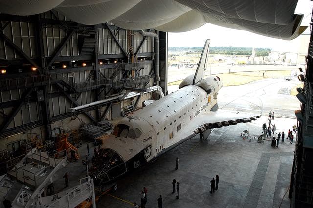 NASA image: KENNEDY SPACE CENTER, FLA. - The Space Shuttle orbiter Atlantis is almost in position in high bay 4 of the Vehicle Assembly Building (VAB).  It was towed from the Orbiter Processing Facility (OPF) to allow work to be performed in the bay that can only be accomplished while it is empty. Work scheduled in the processing facility includes annual validation of the bay's cranes, work platforms, lifting mechanisms, and jack stands. Atlantis will remain in the VAB for about 10 days, then return to the OPF as work resumes to prepare it for launch in September 2004 on the first return-to-flight mission, STS-114.