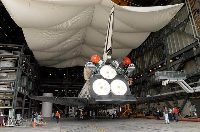NASA image: KENNEDY SPACE CENTER, FLA. - The Space Shuttle orbiter Atlantis arrives in high bay 4 of the Vehicle Assembly Building (VAB).  It was towed from the Orbiter Processing Facility (OPF) to allow work to be performed in the bay that can only be accomplished while it is empty. Work scheduled in the processing facility includes annual validation of the bay's cranes, work platforms, lifting mechanisms, and jack stands. Atlantis will remain in the VAB for about 10 days, then return to the OPF as work resumes to prepare it for launch in September 2004 on the first return-to-flight mission, STS-114.
