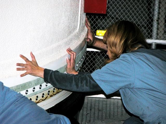 NASA image: KENNEDY SPACE CENTER, FLA. -  In the Vehicle Assembly Building, a KSC employee separates the forward assembly (nose cap and frustum) from a solid rocket booster (SRB) after the bolts were removed.  The destacking is part of time and cycle activities.  The SRB was part of the stack on Atlantis originally scheduled for a March 1, 2003, launch on mission STS-114.  The SRBs and external tank were demated in February 2003.   The mission is now scheduled to occur no earlier than Sept. 12, 2004, on Atlantis.