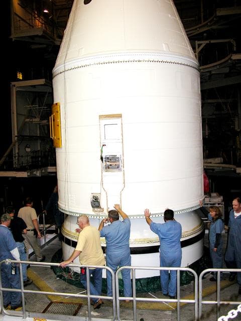 NASA image: KENNEDY SPACE CENTER, FLA. -  In the Vehicle Assembly Building, KSC employees help guide the destacking of the forward assembly (nose cap and frustum) from a solid rocket booster (SRB) after the bolts were removedThe destacking is part of time and cycle activities.  The SRB was part of the stack on Atlantis originally scheduled for a March 1, 2003, launch on mission STS-114.  The SRBs and external tank were demated in February 2003.   The mission is now scheduled to occur no earlier than Sept. 12, 2004, on Atlantis.