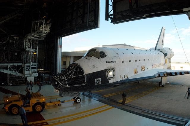 NASA image: KENNEDY SPACE CENTER, FLA. -  The orbiter Atlantis rolls into the Orbiter Processing Facility after spending 10 days in the Vehicle Assembly Building.  The hiatus in the VAB allowed work to be performed in the OPF that can only be accomplished while the bay is empty. Work included annual validation of the bay's cranes, work platforms, lifting mechanisms and jack stands.  Work resumes to prepare Atlantis for launch in September 2004 on the first return-to-flight mission, STS-114.