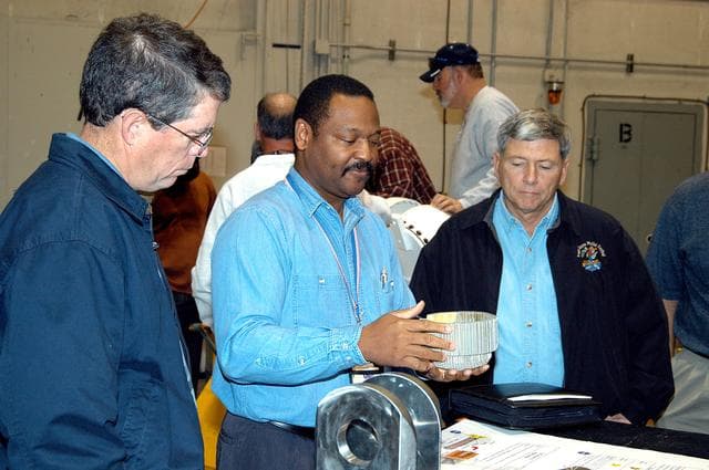 NASA image: KENNEDY SPACE CENTER, FLA. -- A United Space Alliance (USA) technician (center) discusses aspects of Shuttle processing performed in the Solid Rocket Booster (SRB) Assembly and Refurbishment Facility (ARF) with NASA Deputy Associate Administrator for Space Station and Shuttle Programs Michael Kostelnik (right).  NASA and USA Space Shuttle program management are participating in a leadership workday.  The day is intended to provide management with an in-depth, hands-on look at Shuttle processing activities at KSC.